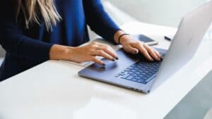 woman typing on laptop