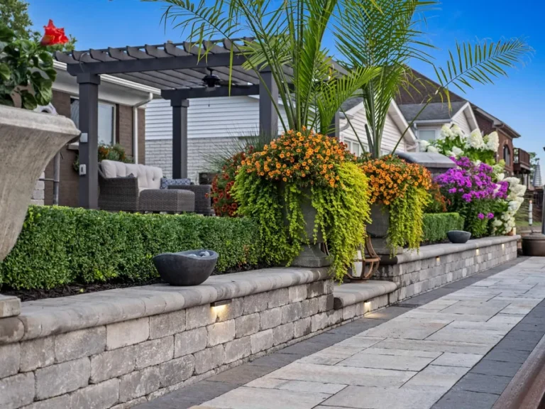 Antonelli Landscape paver walkway and planted retaining wall at dusk