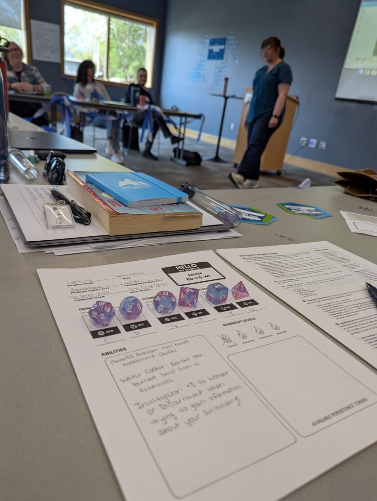 A game sheet with dice and an instructor facilitating a game with the Avalanche Team.