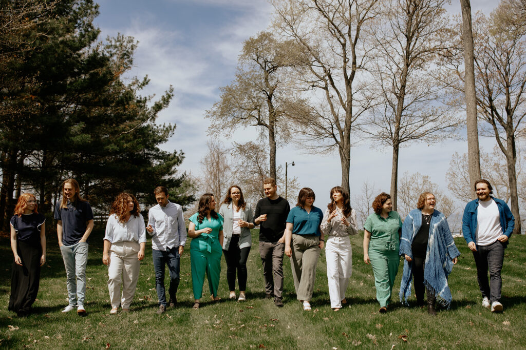 Team members walk in a straight line while having conversations.