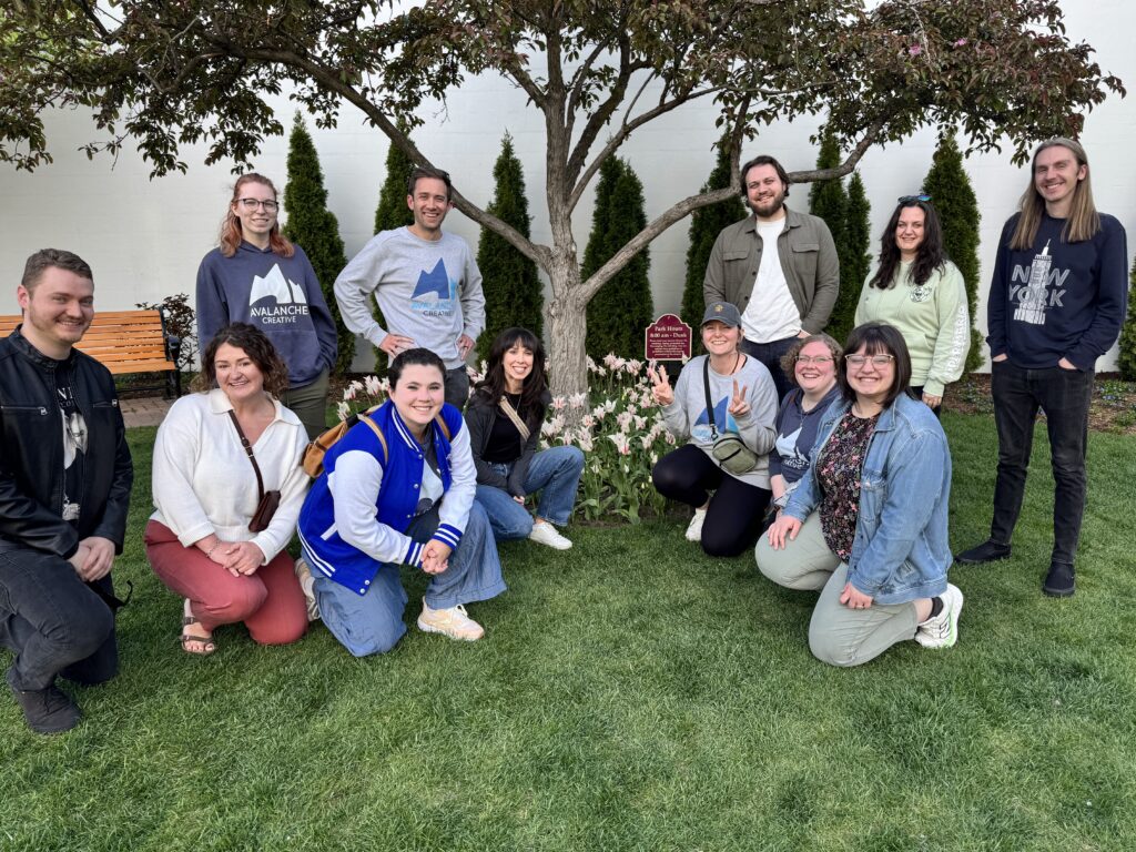 The Avalanche team gathers around a tree and tulips in Holland