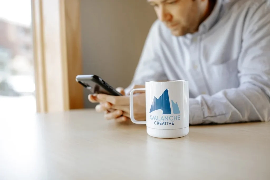 Phone and Avalanche mug on a desk